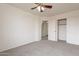 Cozy bedroom featuring plush carpet, ceiling fan, and closet with sliding doors, perfect for relaxation at 35030 N Barzona Trl, San Tan Valley, AZ 85143