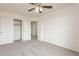 Bright bedroom features carpet, a ceiling fan, and closet with sliding doors for storage at 35030 N Barzona Trl, San Tan Valley, AZ 85143