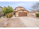 Two-story home with a desert landscape, two car garage, and a charming arched entry at 35030 N Barzona Trl, San Tan Valley, AZ 85143