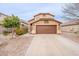 Two-story home with a desert landscape, two car garage, and a charming arched entry at 35030 N Barzona Trl, San Tan Valley, AZ 85143