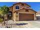 Two-story home with a desert landscape, two car garage, and a charming arched entry at 35030 N Barzona Trl, San Tan Valley, AZ 85143