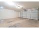 Spacious garage with concrete floor and overhead lighting perfect for parking or storage at 35030 N Barzona Trl, San Tan Valley, AZ 85143