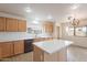 Bright kitchen featuring an island, stainless steel appliances and light wood cabinets at 35030 N Barzona Trl, San Tan Valley, AZ 85143