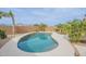 Backyard swimming pool area with desert landscaping and blue sky in the background at 35030 N Barzona Trl, San Tan Valley, AZ 85143