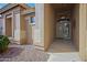 Inviting front entrance with a decorative light fixture, stone accents, and a well-kept landscape at 3768 N 162Nd Ln, Goodyear, AZ 85395