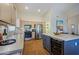 Spacious kitchen with stainless steel appliances, including wine fridge, and stone countertops for seamless meal preparation at 3768 N 162Nd Ln, Goodyear, AZ 85395