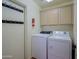 Functional laundry room with full sized washer and dryer and overhead storage at 3768 N 162Nd Ln, Goodyear, AZ 85395