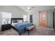 Spacious main bedroom featuring a ceiling fan, ensuite bathroom with a walk-in closet, and natural lighting at 3768 N 162Nd Ln, Goodyear, AZ 85395