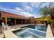 Beautiful backyard featuring a pool, hot tub, patio, and lush palm tree landscape at 3768 N 162Nd Ln, Goodyear, AZ 85395