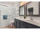 Bathroom featuring a glass enclosed shower and a dual sink vanity with framed mirrors and warm neutral tones at 41260 N Salix Dr, San Tan Valley, AZ 85140