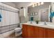 Bathroom featuring dual sinks, wood vanity, and a shower/tub combo with neutral walls and decorative accents at 41260 N Salix Dr, San Tan Valley, AZ 85140