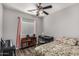 Bedroom featuring a ceiling fan, desk area and a large window, offering a bright and functional living space at 41260 N Salix Dr, San Tan Valley, AZ 85140