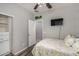 Bright bedroom featuring a ceiling fan, TV, and closet, offering a comfortable and functional living space at 41260 N Salix Dr, San Tan Valley, AZ 85140