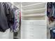 A well-organized closet with white shelving and drawers filled with clothing providing ample storage space at 41260 N Salix Dr, San Tan Valley, AZ 85140