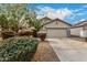 Charming home exterior with a two-car garage and beautiful desert landscaping at 41260 N Salix Dr, San Tan Valley, AZ 85140