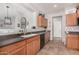 Well-lit kitchen featuring wood cabinets, tile floors, and modern appliances at 41260 N Salix Dr, San Tan Valley, AZ 85140