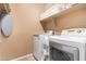 Bright laundry room with a washer, dryer, shelving, and ample space for organizing at 41260 N Salix Dr, San Tan Valley, AZ 85140