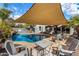 Backyard pool and patio area complete with comfortable seating, shaded by a stylish pergola at 41260 N Salix Dr, San Tan Valley, AZ 85140