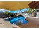 Backyard swimming pool oasis featuring a rock waterfall, slide and a shaded seating area at 41260 N Salix Dr, San Tan Valley, AZ 85140