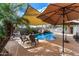 Inviting backyard pool with a waterfall feature, surrounded by lounge chairs and a shaded pergola at 41260 N Salix Dr, San Tan Valley, AZ 85140