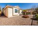 Low-maintenance backyard features a covered patio with an outdoor dining set and decorative stucco wall at 4189 E Sandy Way, Gilbert, AZ 85297