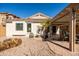 Cozy backyard features a covered patio, low-maintenance desert landscaping, and exterior window at 4189 E Sandy Way, Gilbert, AZ 85297