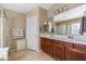 Bright bathroom featuring a double vanity, walk-in shower, and tile floors at 4189 E Sandy Way, Gilbert, AZ 85297