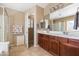 Bright bathroom featuring a double vanity, walk-in shower, and tile floors at 4189 E Sandy Way, Gilbert, AZ 85297