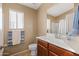 Well-maintained bathroom featuring a vanity with a sink, a toilet, and a shower with a curtain at 4189 E Sandy Way, Gilbert, AZ 85297