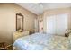 Comfortable bedroom with a patterned quilt, dresser, and a well-lit window, exuding tranquility at 4189 E Sandy Way, Gilbert, AZ 85297