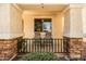 Cozy covered porch with decorative columns and chairs, perfect for relaxing outdoors at 4189 E Sandy Way, Gilbert, AZ 85297