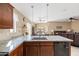 Kitchen island with granite counters and a sink overlooking the dining and living areas at 4189 E Sandy Way, Gilbert, AZ 85297