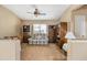 Cozy living room with comfortable plaid loveseat, cabinets, and ceiling fan at 4189 E Sandy Way, Gilbert, AZ 85297