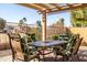 Relaxing patio features a dining set with a table and four chairs under a pergola at 4189 E Sandy Way, Gilbert, AZ 85297