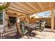 Covered patio with a dining table set, ceiling fan, and sliding door access to the house at 4189 E Sandy Way, Gilbert, AZ 85297