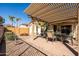 Charming backyard patio under a pergola, perfect for outdoor dining and entertaining with a patio set at 4189 E Sandy Way, Gilbert, AZ 85297