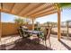 Covered patio features a dining set for four on brick pavers and an outdoor grill at 4189 E Sandy Way, Gilbert, AZ 85297