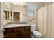 Bathroom featuring a vanity with dark cabinets and a shower with curtain at 4251 N Golf Dr, Buckeye, AZ 85396