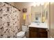 Bathroom showcasing a vanity, toilet, and shower with patterned curtain at 4251 N Golf Dr, Buckeye, AZ 85396