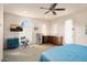 Bedroom featuring a ceiling fan, wet bar, a small fridge, and a walk-in closet at 4251 N Golf Dr, Buckeye, AZ 85396