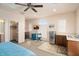 Bedroom showcasing a ceiling fan, wet bar, a small fridge, and a walk-in closet at 4251 N Golf Dr, Buckeye, AZ 85396