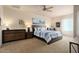 Comfortable bedroom featuring a plush bed, ceiling fan, and ample natural light at 4251 N Golf Dr, Buckeye, AZ 85396