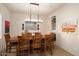 Classic dining room with hardwood table, decorative lighting, and seating for eight at 4251 N Golf Dr, Buckeye, AZ 85396