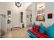 Bright entryway with tile flooring, stylish bench, art, and ample natural light from adjacent windows at 4251 N Golf Dr, Buckeye, AZ 85396