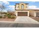 Inviting two-story home with a brown garage door, desert landscaping, and a well-manicured front yard at 4251 N Golf Dr, Buckeye, AZ 85396