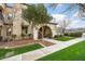 Inviting home exterior with lush lawn, mature tree, covered porch, and well-maintained landscaping at 4251 N Golf Dr, Buckeye, AZ 85396