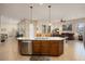 Spacious kitchen island with granite counters, stainless steel appliances, and pendant lighting at 4251 N Golf Dr, Buckeye, AZ 85396