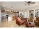 Inviting living space with tile floors, large windows, and a seamless transition to the kitchen at 4251 N Golf Dr, Buckeye, AZ 85396