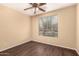 Neutral bedroom features wood-look floors, ceiling fan, and window with horizontal blinds at 4255 E Cloudburst Ct, Gilbert, AZ 85297