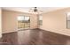 Bedroom with wood flooring, sliding glass doors, and ample natural light from windows at 4255 E Cloudburst Ct, Gilbert, AZ 85297